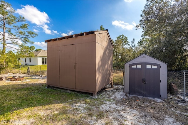 view of shed featuring fence