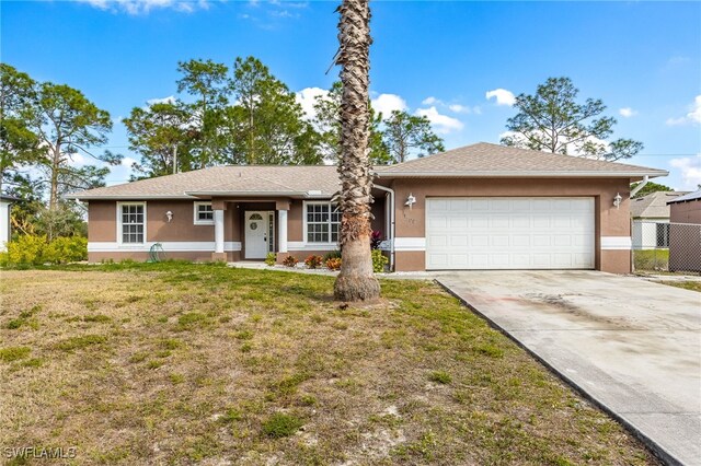 single story home featuring a front lawn and a garage