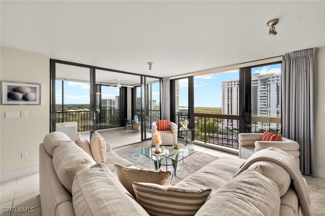 living room featuring a wall of windows, light tile patterned floors, and a wealth of natural light