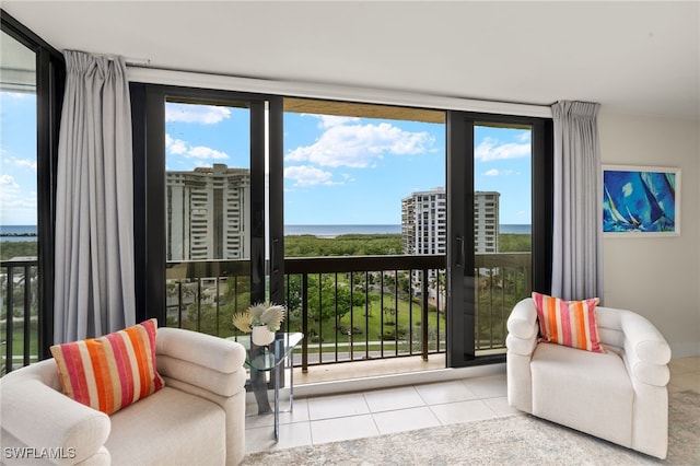 doorway featuring a water view, tile patterned flooring, and expansive windows