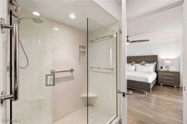 bathroom featuring an enclosed shower, ceiling fan, and wood-type flooring