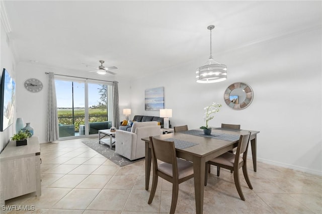 dining space featuring ceiling fan with notable chandelier, ornamental molding, and light tile patterned floors