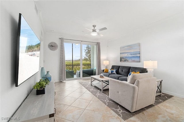 tiled living room with ceiling fan and crown molding