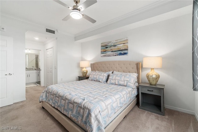 carpeted bedroom featuring crown molding, ensuite bathroom, and ceiling fan