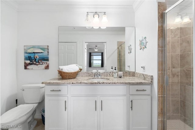 bathroom featuring crown molding, toilet, a shower with shower door, and vanity