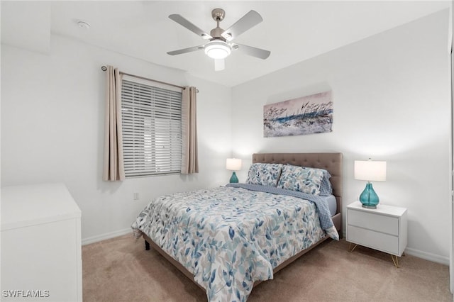 bedroom featuring light carpet and ceiling fan