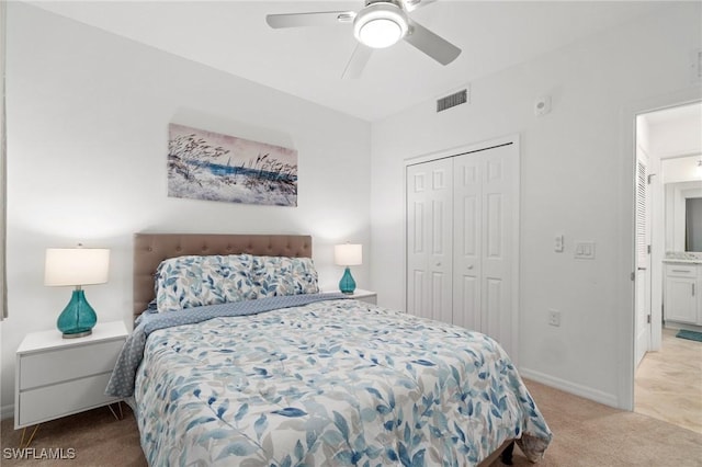 bedroom featuring ceiling fan, a closet, and light carpet