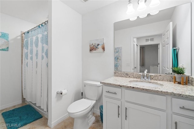 bathroom with tile patterned floors, toilet, vanity, and walk in shower