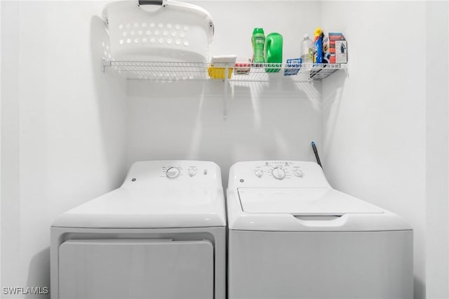 washroom with washing machine and clothes dryer