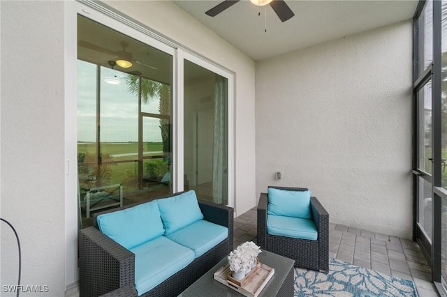 sunroom featuring ceiling fan