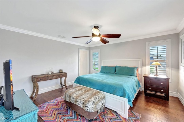 bedroom featuring dark wood-type flooring, ceiling fan, and ornamental molding