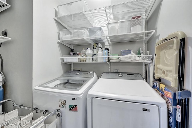 washroom with washing machine and clothes dryer