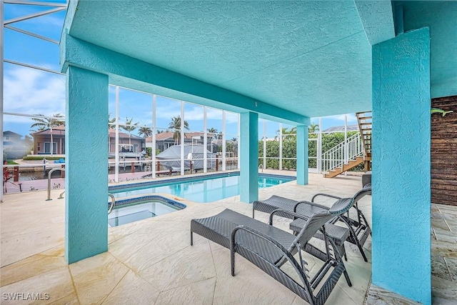 view of swimming pool with an in ground hot tub and a patio area