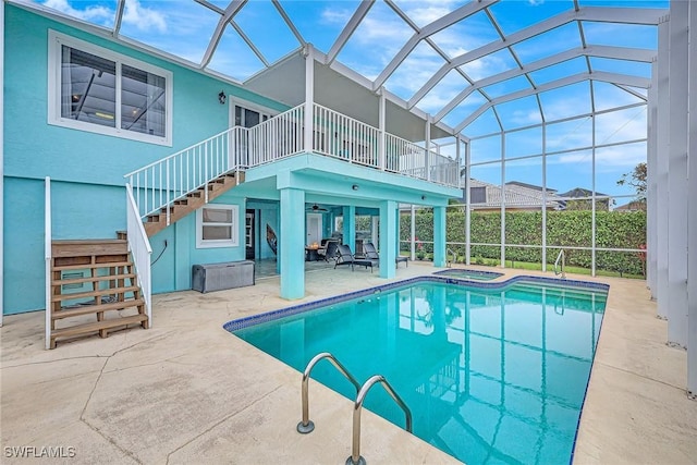 view of pool with an in ground hot tub, a lanai, and a patio