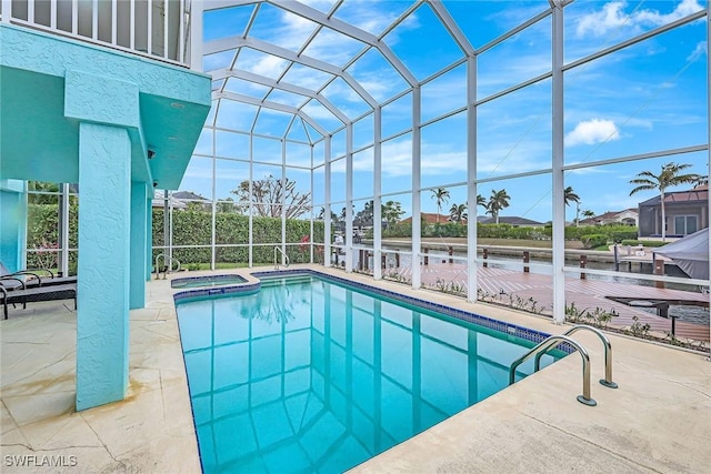 view of swimming pool featuring an in ground hot tub, a patio, and glass enclosure