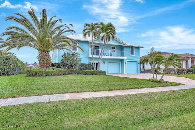 view of front of property with a garage, a front lawn, and a balcony