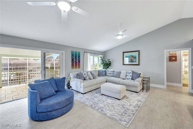 living room with vaulted ceiling, ceiling fan, and light wood-type flooring