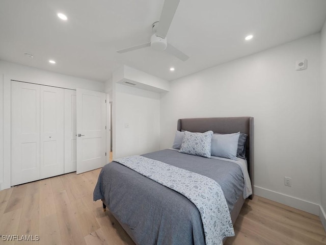 bedroom with light hardwood / wood-style floors, a closet, and ceiling fan