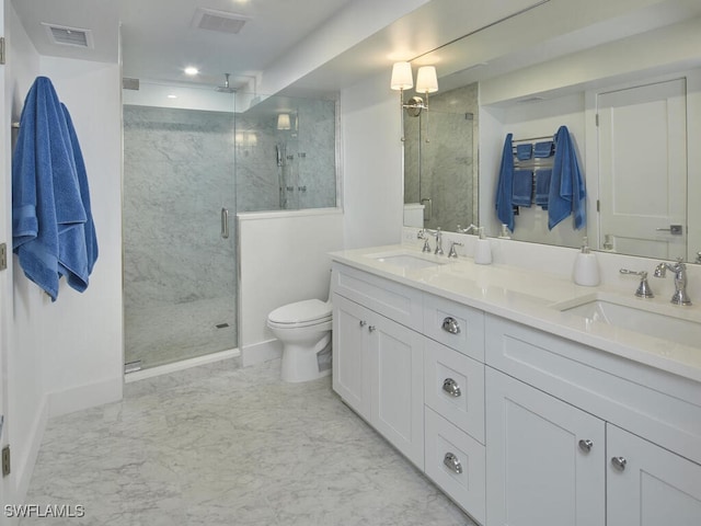 bathroom with vanity, a shower with shower door, and toilet