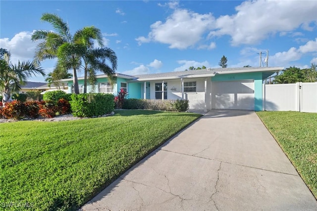 ranch-style house with a garage and a front lawn