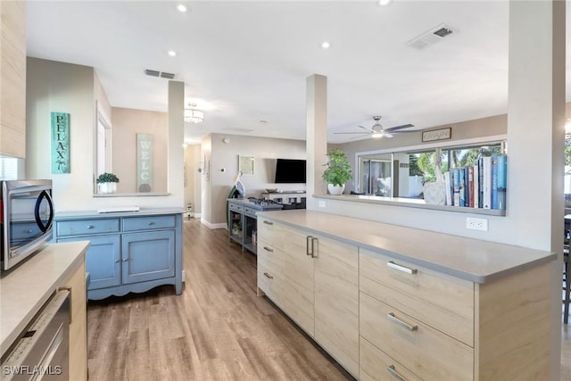 kitchen featuring light hardwood / wood-style flooring, stainless steel appliances, ceiling fan, and light brown cabinets