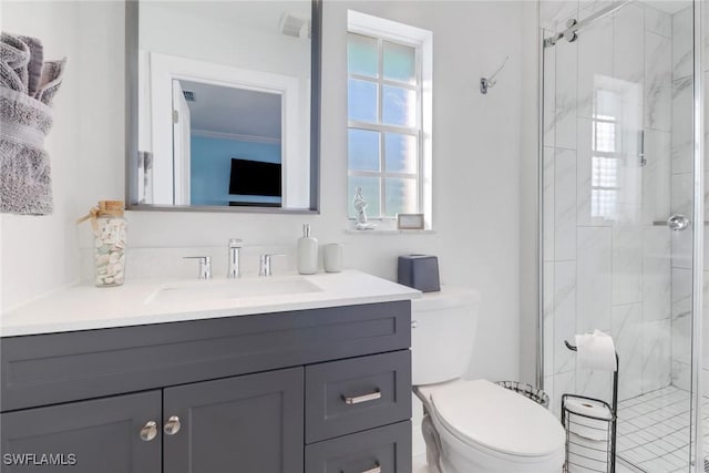 bathroom with an enclosed shower, vanity, and toilet