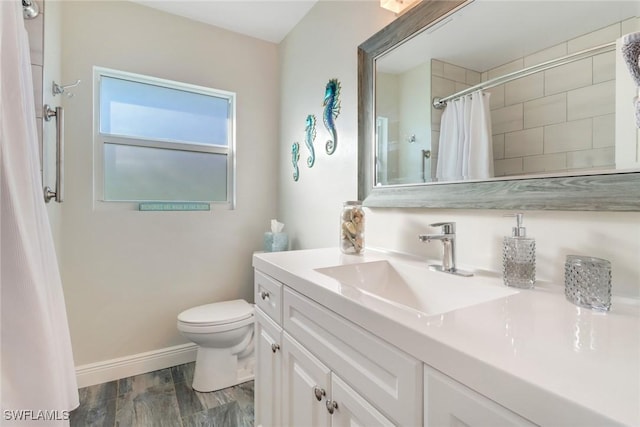 bathroom featuring vanity, hardwood / wood-style floors, toilet, and walk in shower