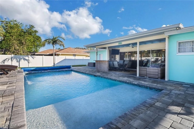 view of swimming pool featuring pool water feature, ceiling fan, and a patio area