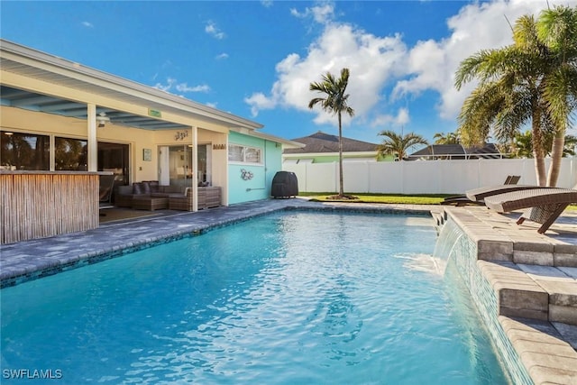 view of swimming pool with a patio, pool water feature, an outdoor hangout area, and a bar