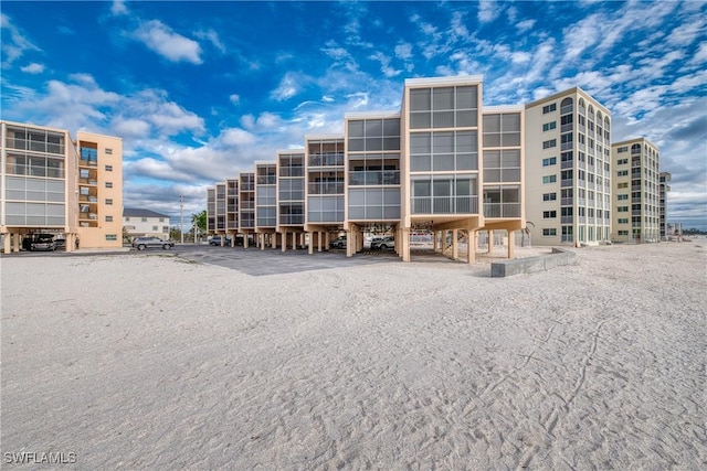 25850 Hickory Blvd Unit A-104, Bonita Springs, FL 34134 - view of apartment building / complex with a parking lot