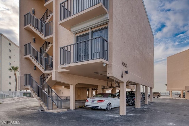 25850 Hickory Blvd Unit A-104, Bonita Springs, FL 34134 - view of apartment building / complex with stairs and covered parking
