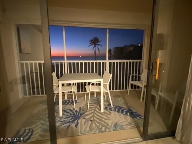 sunroom / solarium with a water view