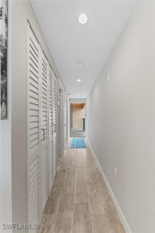 25850 Hickory Blvd Unit A-104, Bonita Springs, FL 34134 - corridor with baseboards, wood finished floors, and recessed lighting