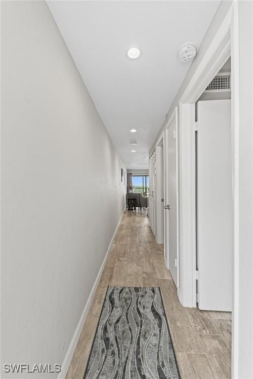 hallway with light hardwood / wood-style flooring