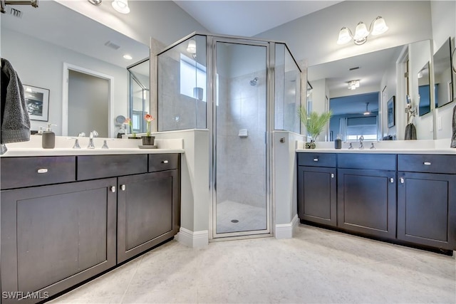 bathroom with tile patterned floors, walk in shower, and vanity