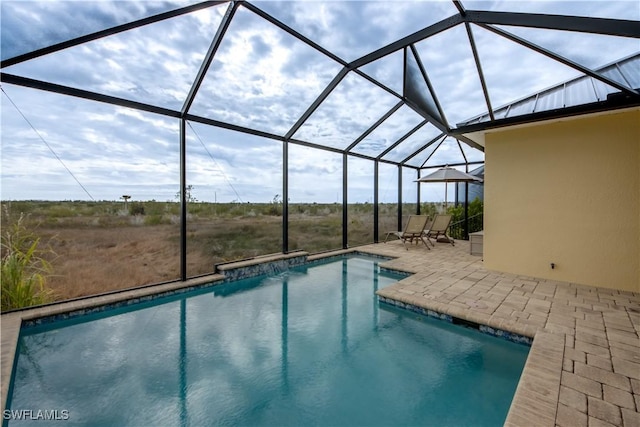 view of swimming pool with a patio and glass enclosure