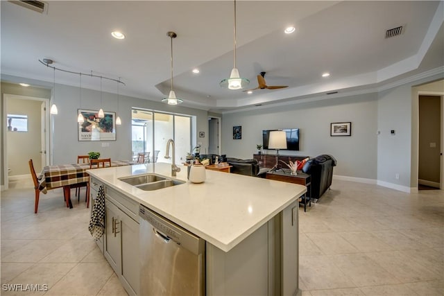 kitchen featuring dishwasher, sink, a raised ceiling, a kitchen island with sink, and ceiling fan