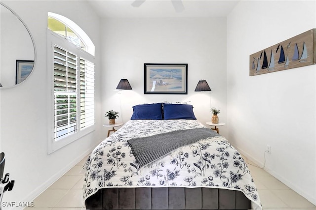 tiled bedroom featuring ceiling fan