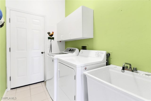 clothes washing area with cabinets, sink, independent washer and dryer, and light tile patterned flooring