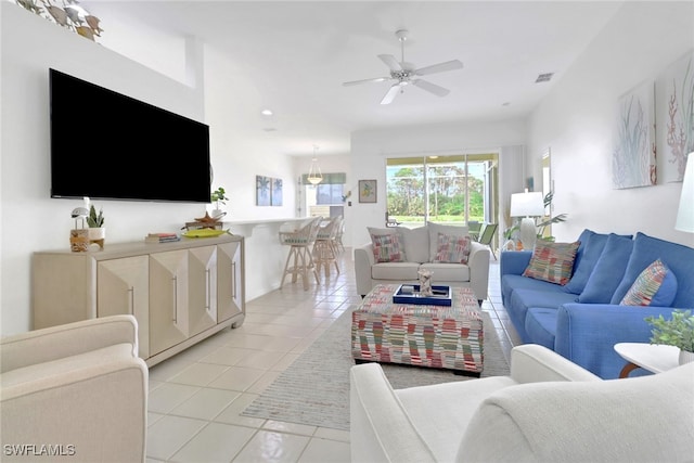 tiled living room featuring ceiling fan