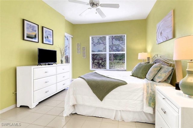 tiled bedroom featuring ceiling fan