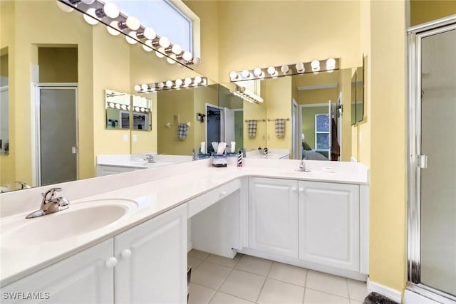 bathroom featuring an enclosed shower, vanity, and tile patterned flooring