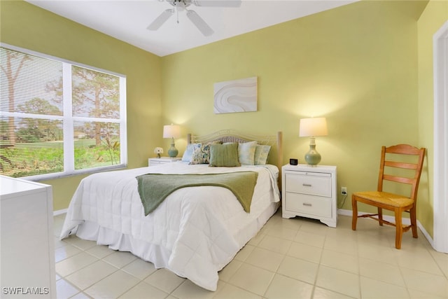 tiled bedroom featuring ceiling fan and multiple windows