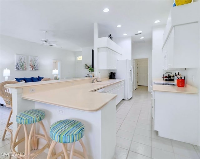 kitchen featuring white cabinetry, kitchen peninsula, and a breakfast bar