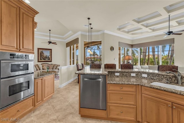 kitchen with appliances with stainless steel finishes, dark stone counters, sink, crown molding, and coffered ceiling