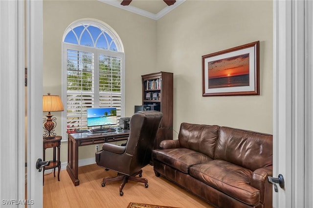 home office with light hardwood / wood-style floors, crown molding, and ceiling fan