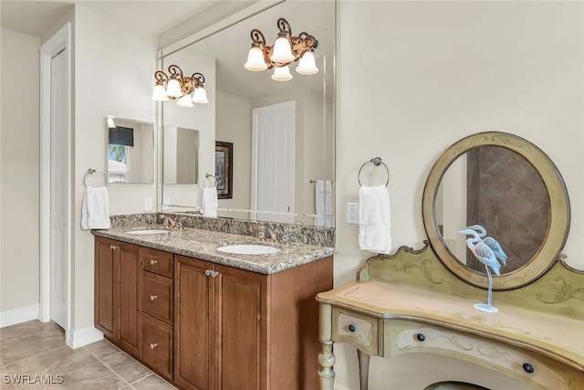 bathroom featuring vanity, a notable chandelier, and tile patterned flooring