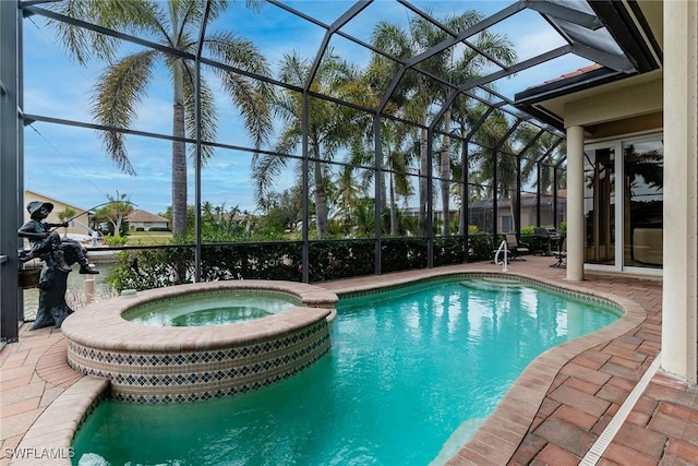 view of swimming pool with an in ground hot tub, a lanai, and a patio area