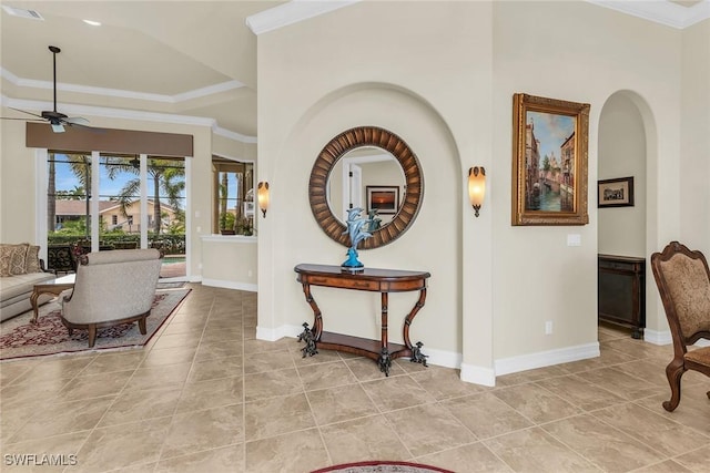 tiled foyer with ceiling fan and ornamental molding