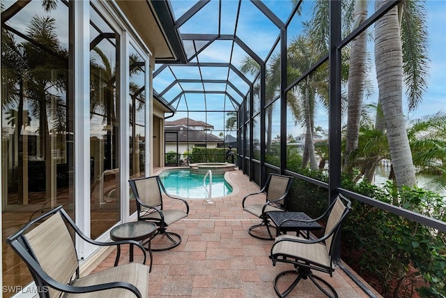 view of swimming pool with an in ground hot tub, a lanai, and a patio